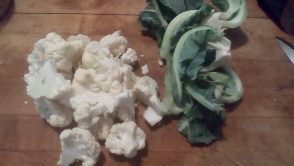Cut the cauliflower into pieces and save the greens and other trimmings for the rabbits or piggies