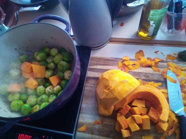 Peel and cut up the squash into differently sized chunks so there are a variety of textures in the finished soup. Once the sprouts start taking on some colour add in the squash. Keep stirring often enough to stop it burning but let the veg take on some good colour and caramelise a bit.