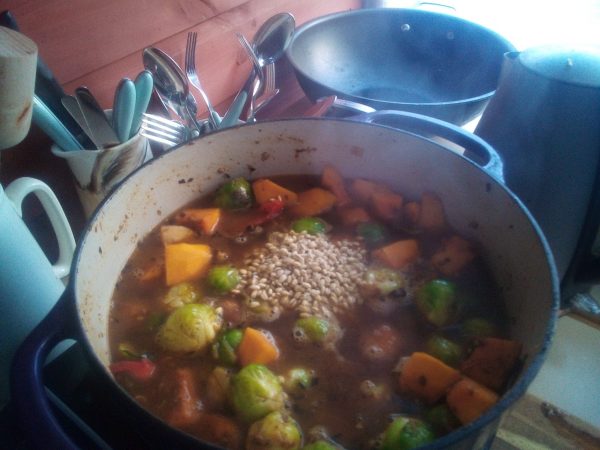 Then add the boiled water to top up the pan and add the barley followed by the milled linseeds. Stir and bring to the boil and then simmer for fifty minutes to cook the barley.